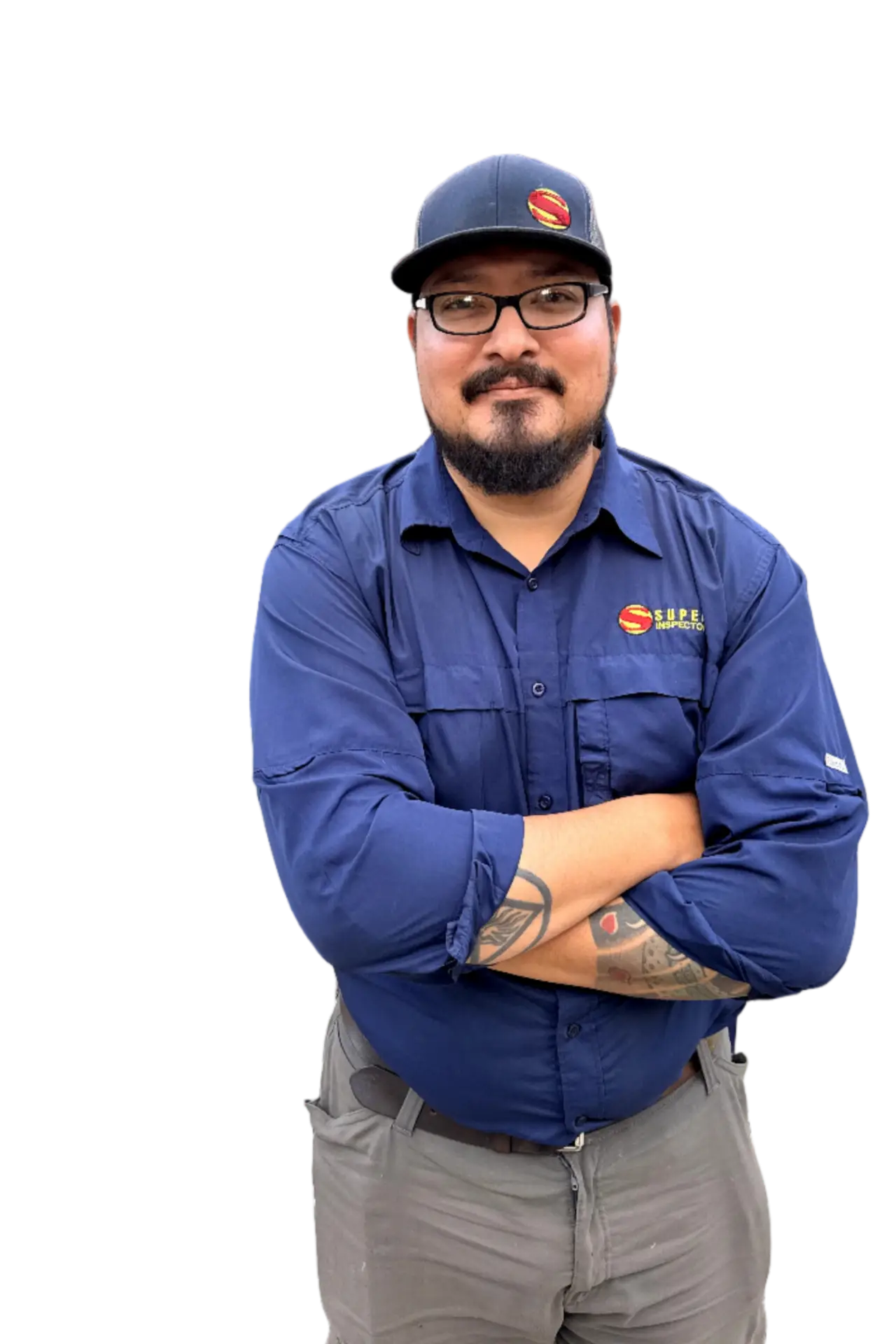 A man with glasses, a mustache, and a beard stands with arms crossed, wearing a navy blue shirt and cap with the S.E.R.S. logo. He has visible tattoos on his left forearm.